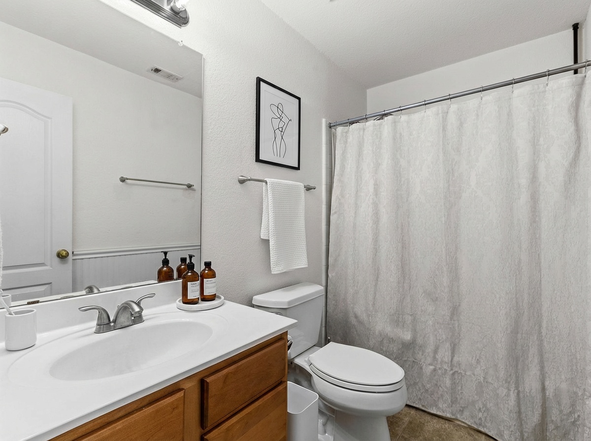 144 Vicksburg Loop Elgin, TX 78621 - Photo 13 of 23 a bathroom with a sink and a toilet