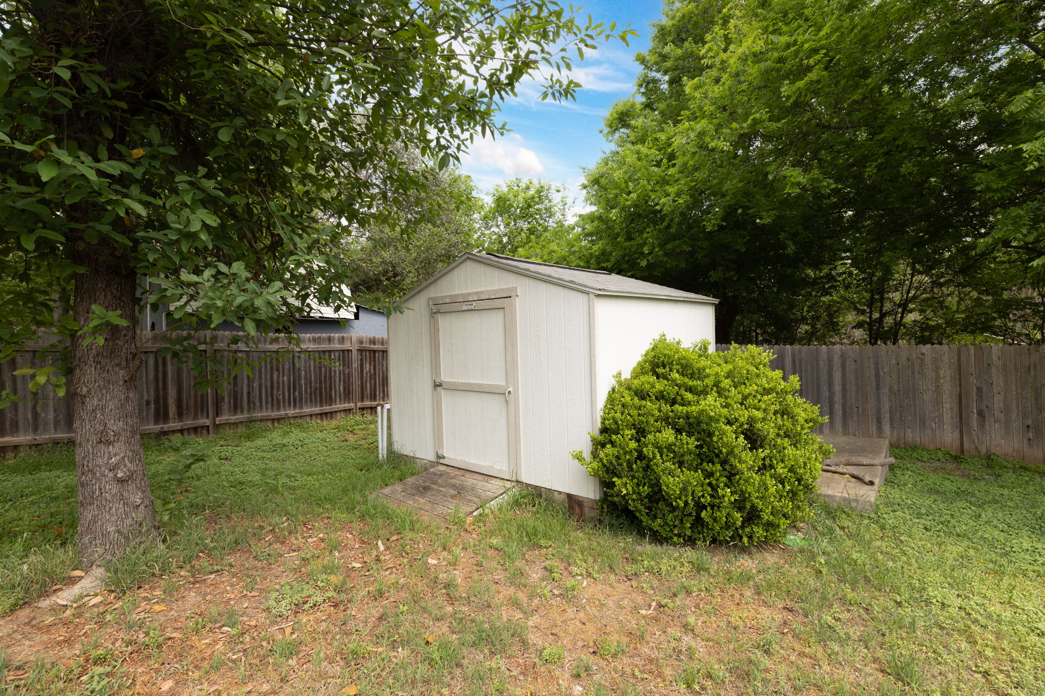 144 Vicksburg Loop Elgin, TX 78621 - Photo 15 of 23 a backyard of a house with plants and tree