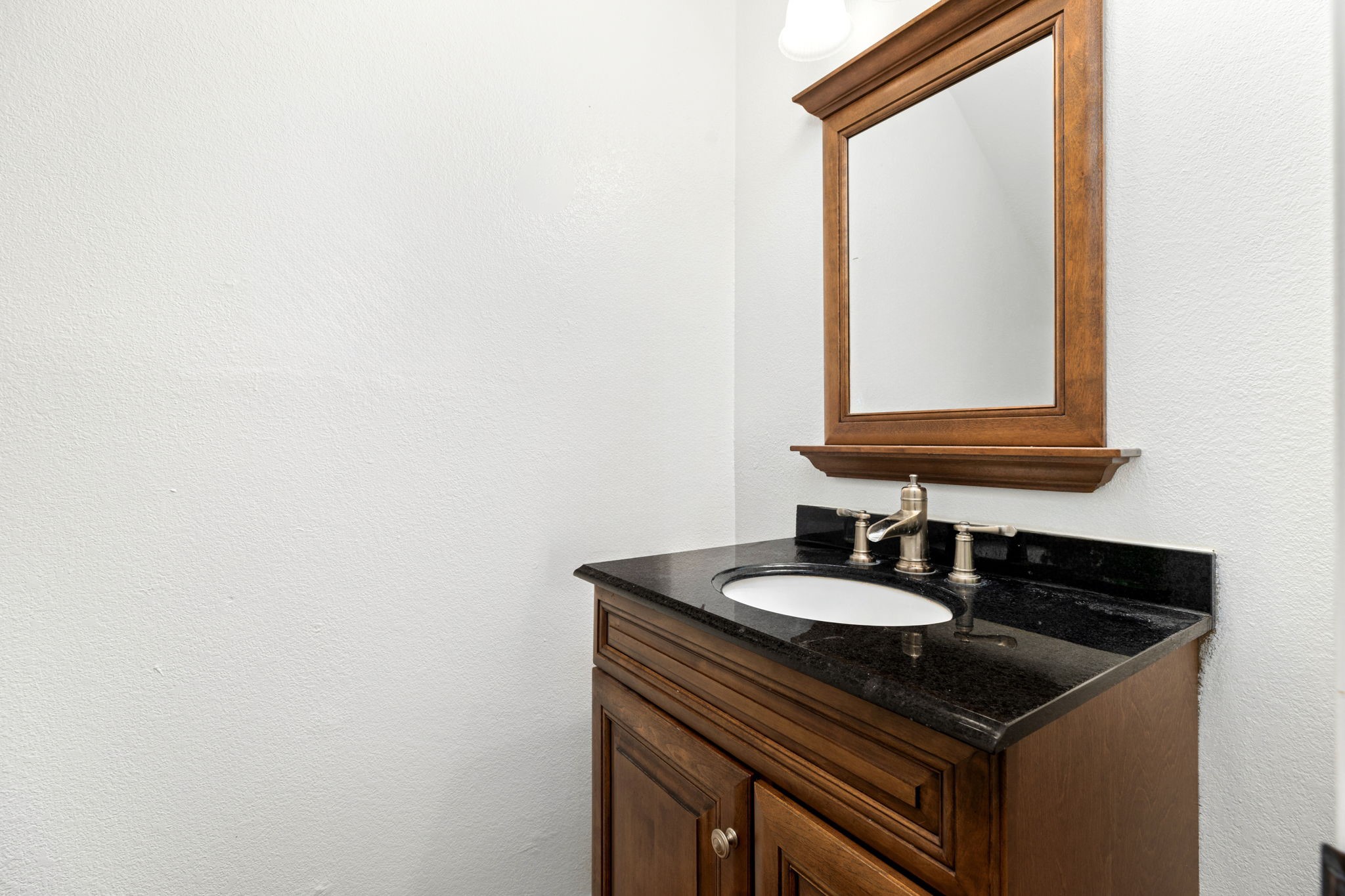 144 Vicksburg Loop Elgin, TX 78621 - Photo 16 of 23 a sink and a mirror