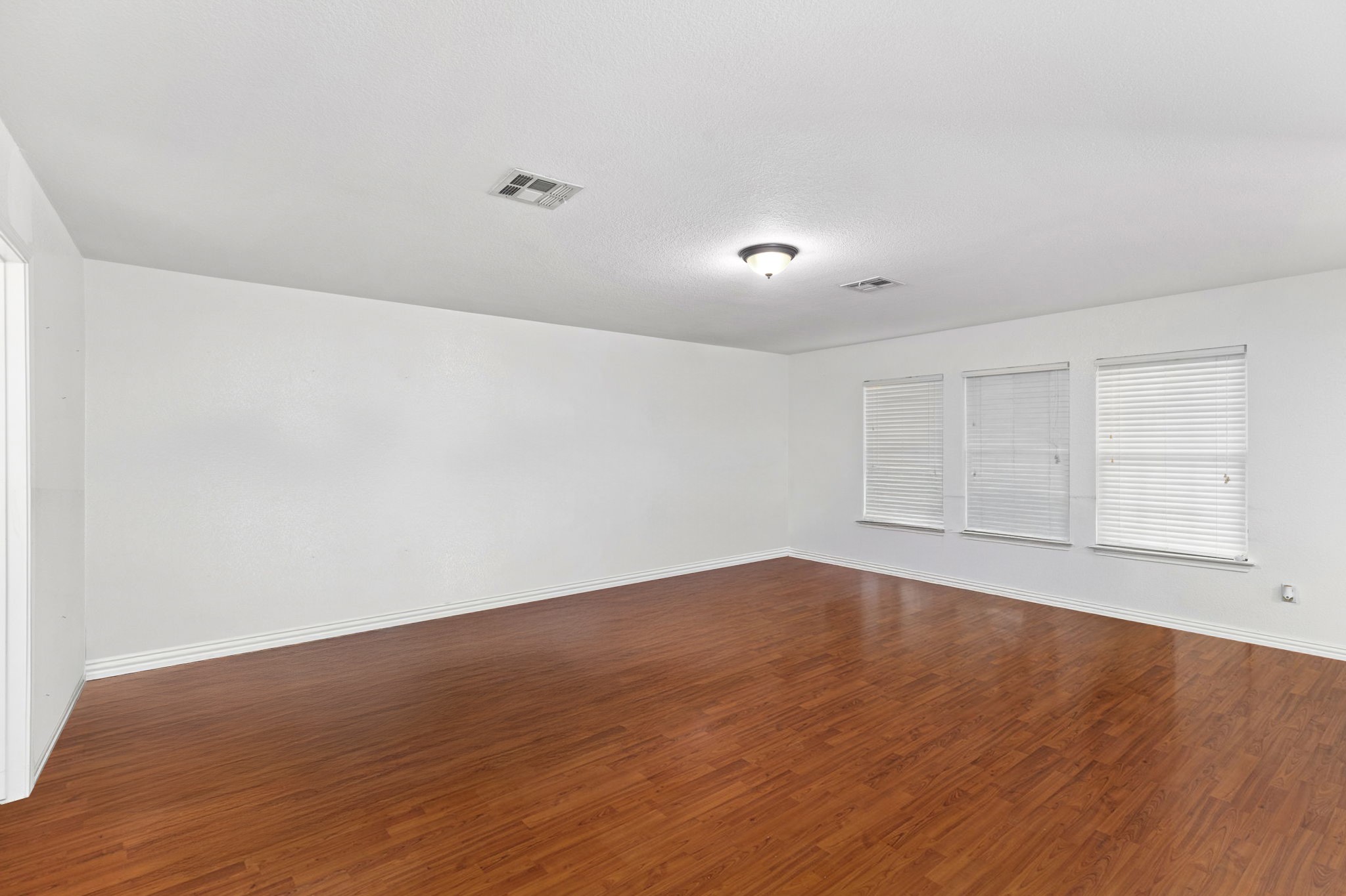 144 Vicksburg Loop Elgin, TX 78621 - Photo 17 of 23 a view of empty room with wooden floor and fan