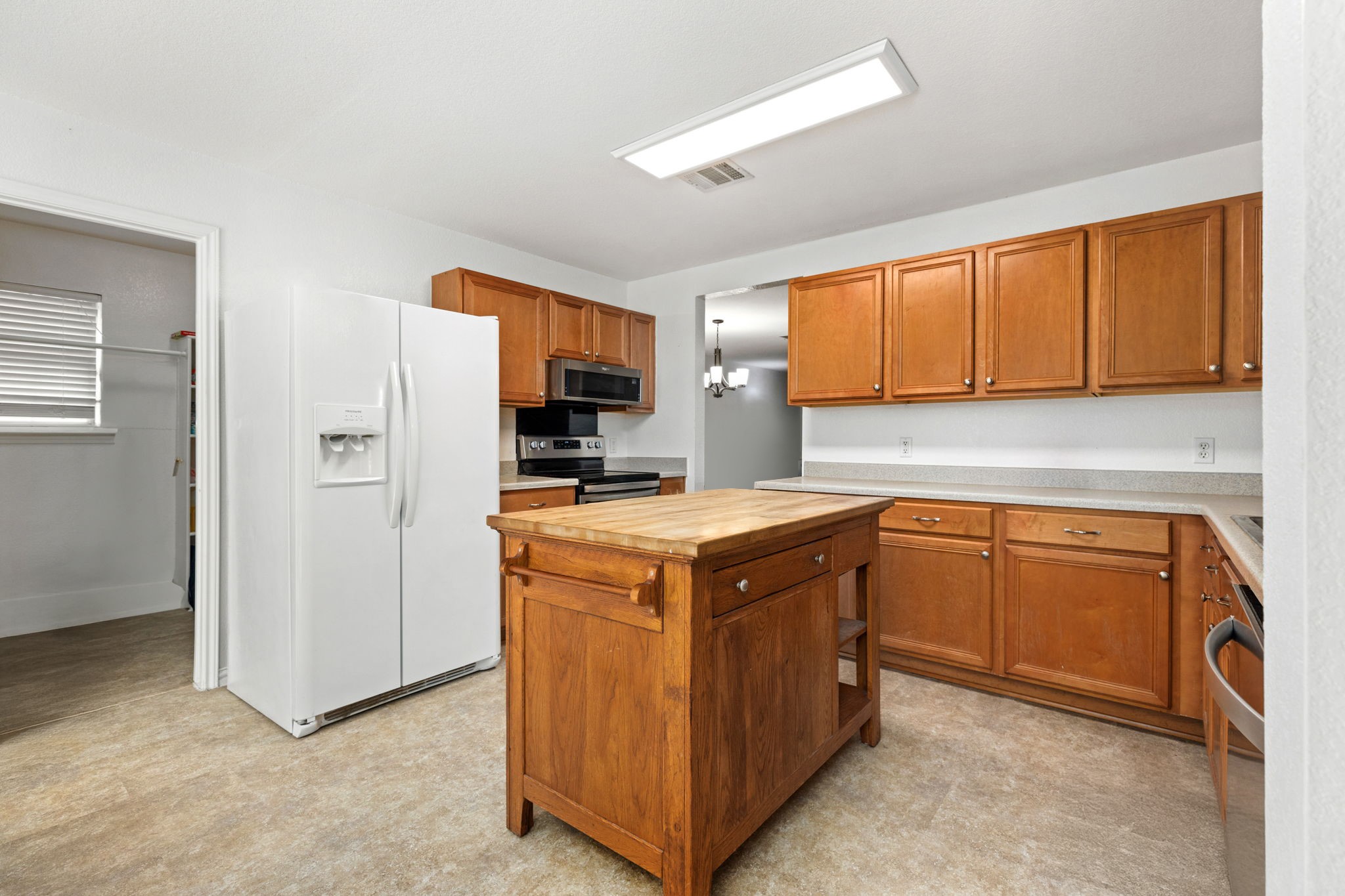 144 Vicksburg Loop Elgin, TX 78621 - Photo 6 of 23 a kitchen with stainless steel appliances granite countertop a stove a refrigerator and a sink