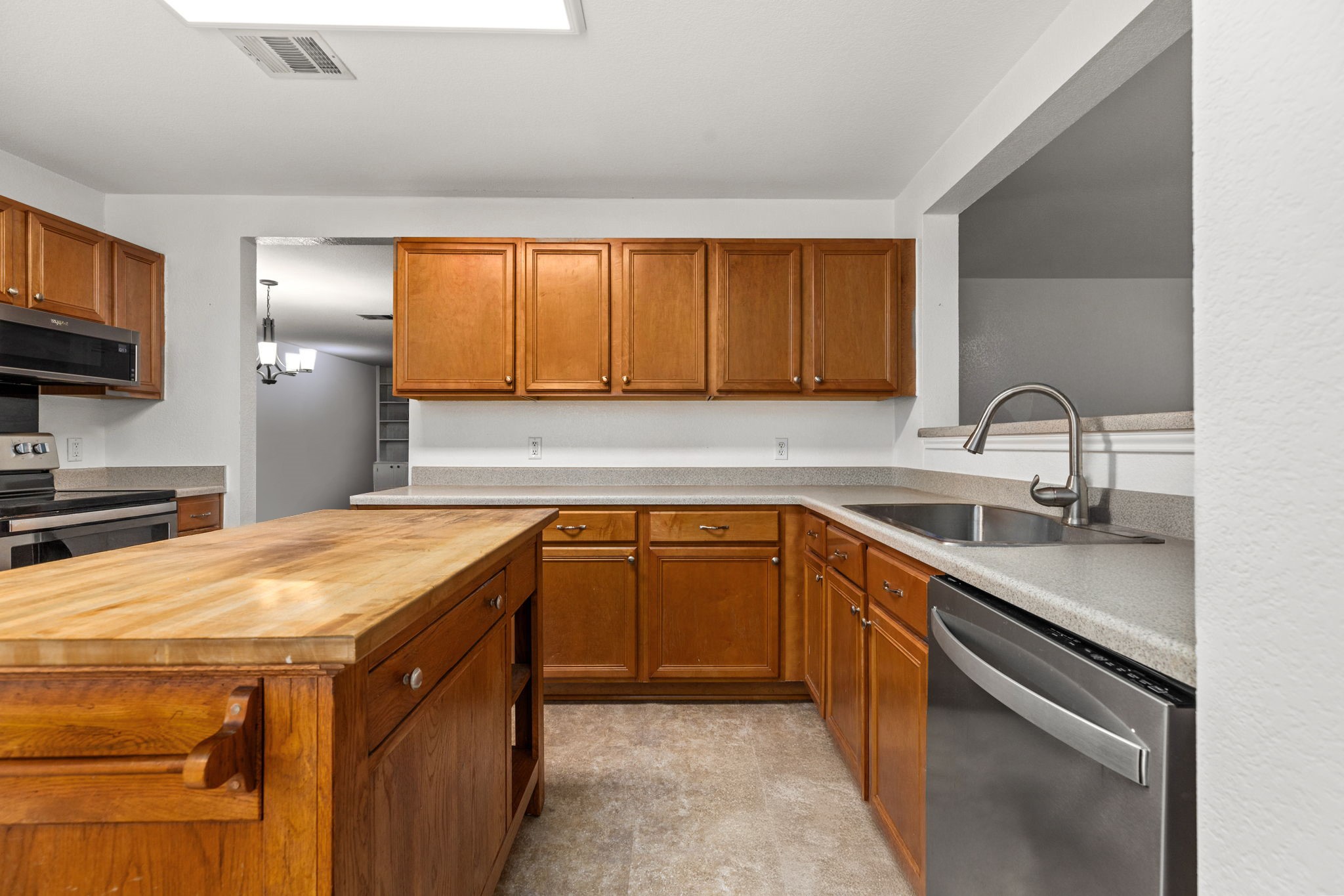 144 Vicksburg Loop Elgin, TX 78621 - Photo 7 of 23 a kitchen with a sink cabinets and a window
