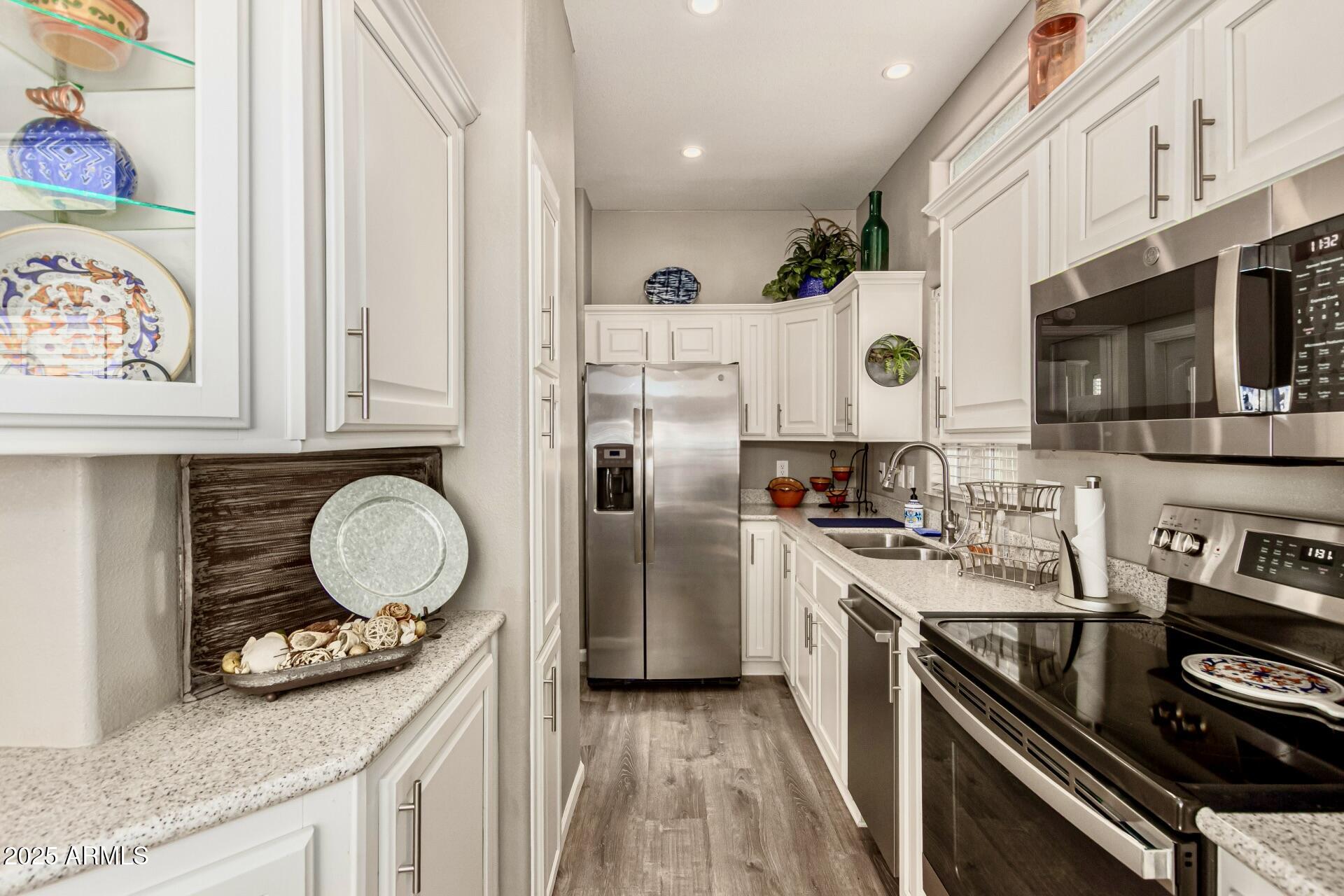 1374 West Chesapeake Avenue Apache Junction, AZ 85119 - Photo 15 of 33 a kitchen with stainless steel appliances a stove a sink and a microwave