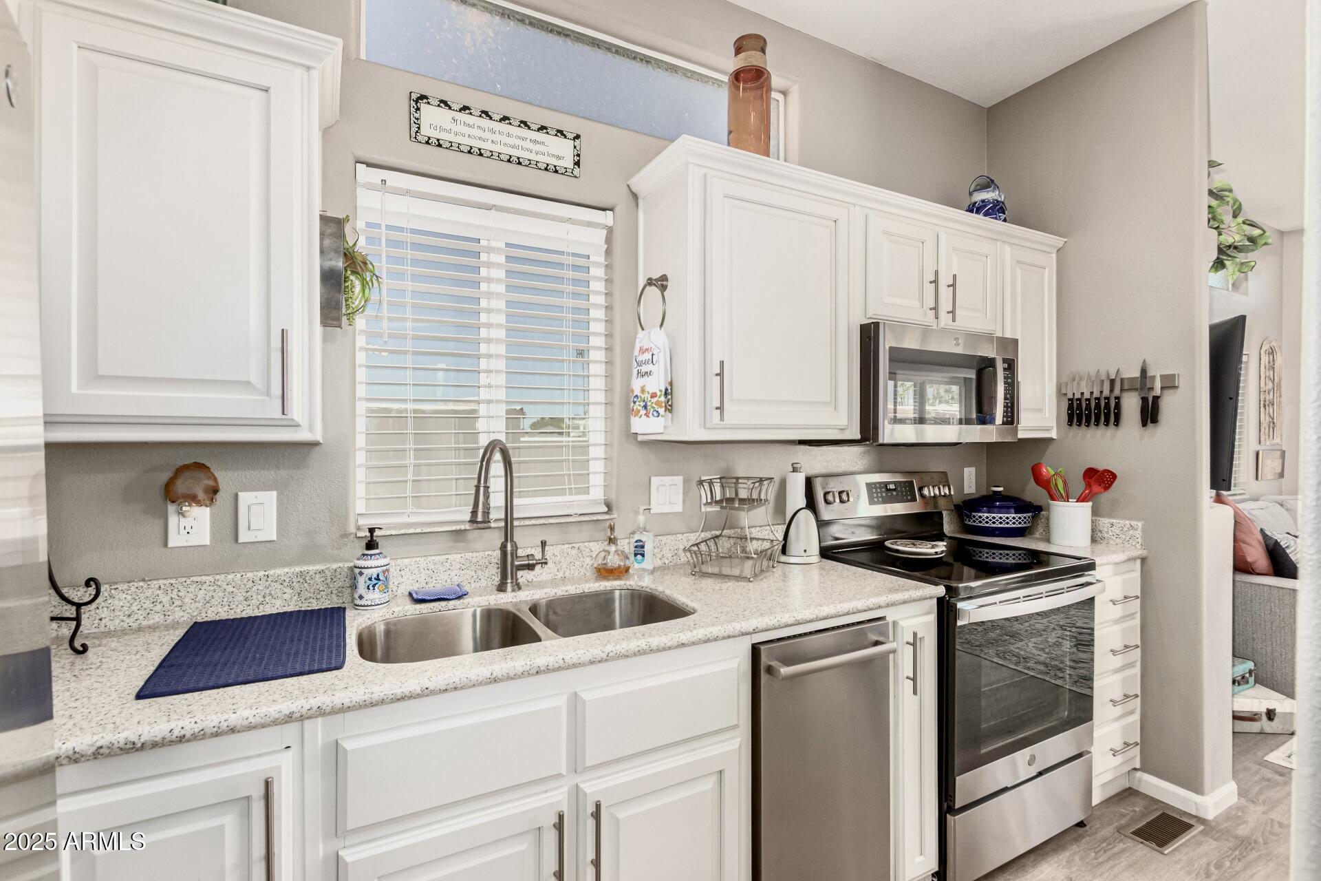 1374 West Chesapeake Avenue Apache Junction, AZ 85119 - Photo 16 of 33 a kitchen with appliances a sink and cabinets