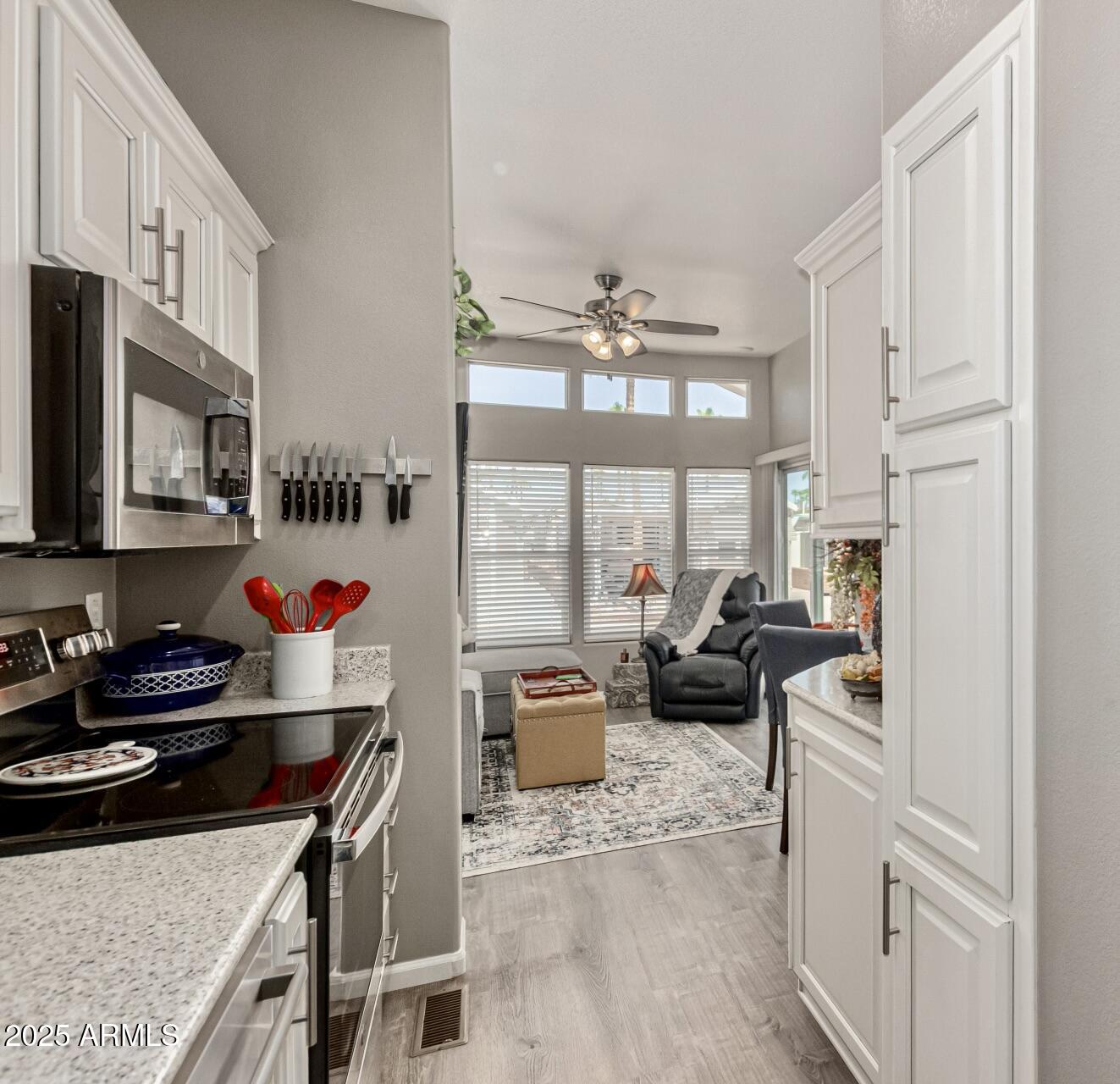 1374 West Chesapeake Avenue Apache Junction, AZ 85119 - Photo 17 of 33 a kitchen with stainless steel appliances kitchen island granite countertop a stove and a sink