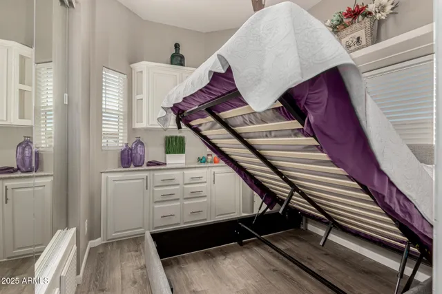 a bathroom with a granite countertop toilet sink and mirror