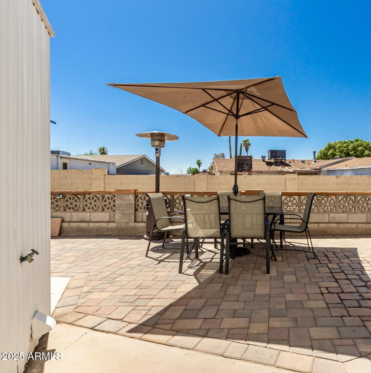 1374 West Chesapeake Avenue Apache Junction, AZ 85119 - Photo 21 of 33 a view of a patio with a table and chairs under an umbrella