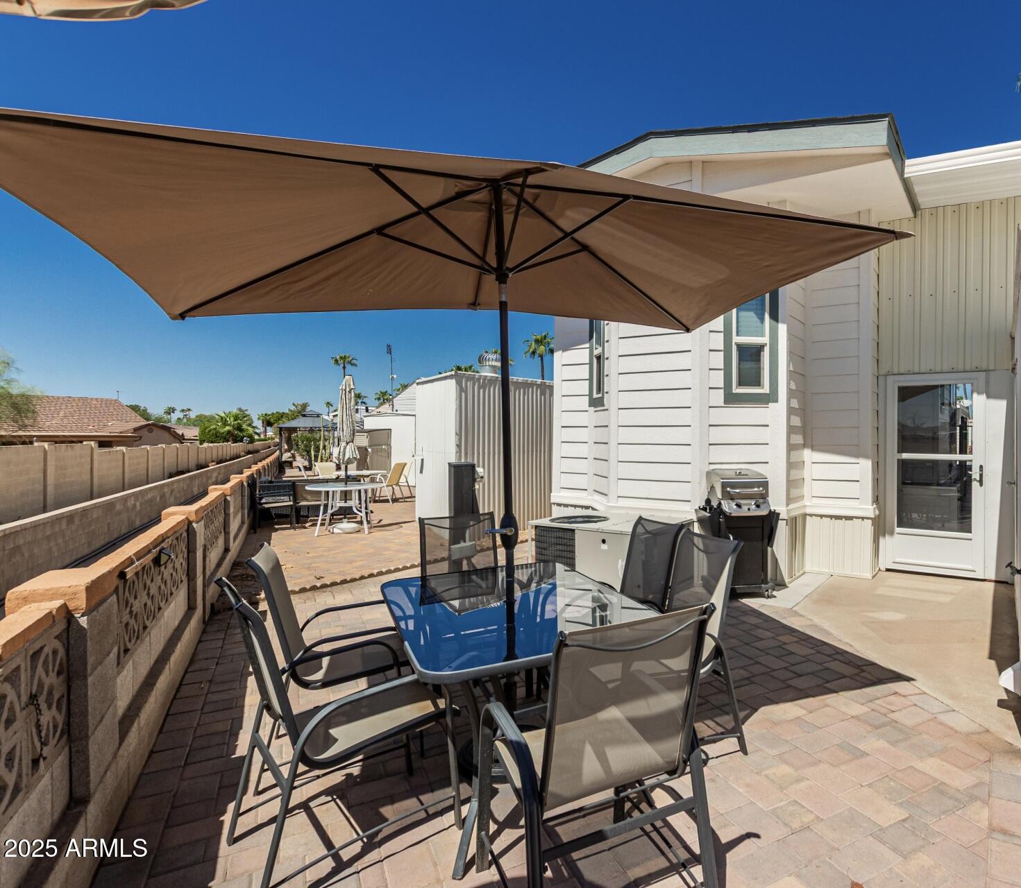 1374 West Chesapeake Avenue Apache Junction, AZ 85119 - Photo 22 of 33 a patio with tables and chairs