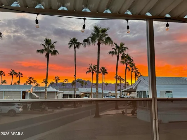 a view of a chairs and table in the backyard
