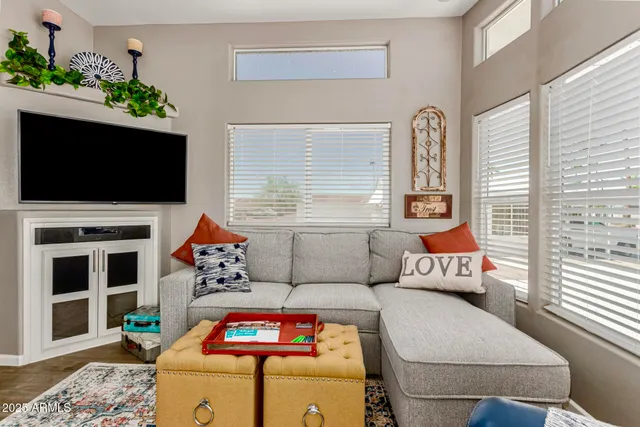 a living room with furniture and a floor to ceiling window