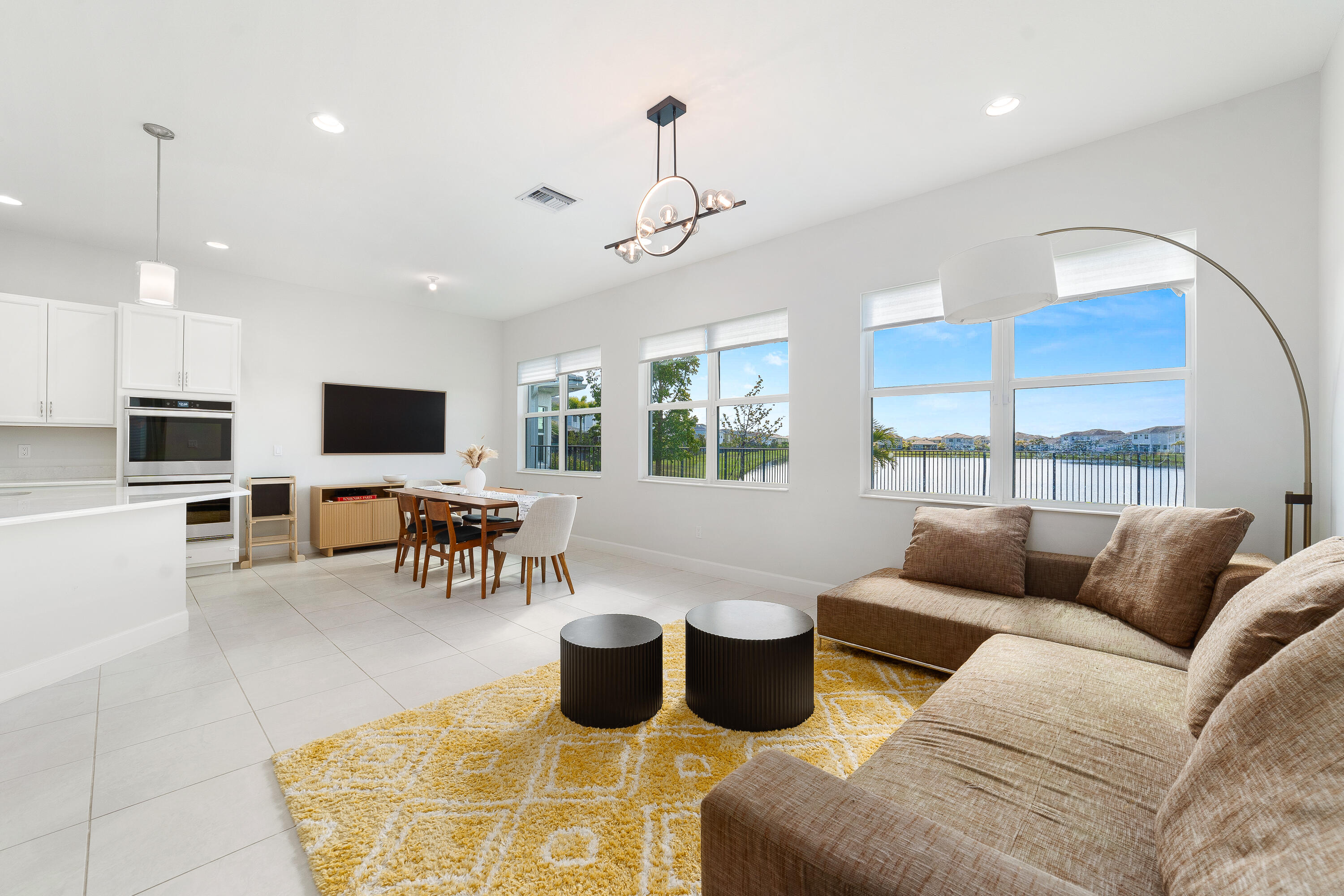 5487 Macoon Way Loxahatchee, FL 33470 - Photo 14 of 66 a living room with furniture a flat screen tv and a large window