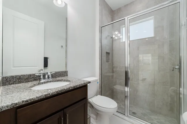 a white toilet sitting next to a white wall