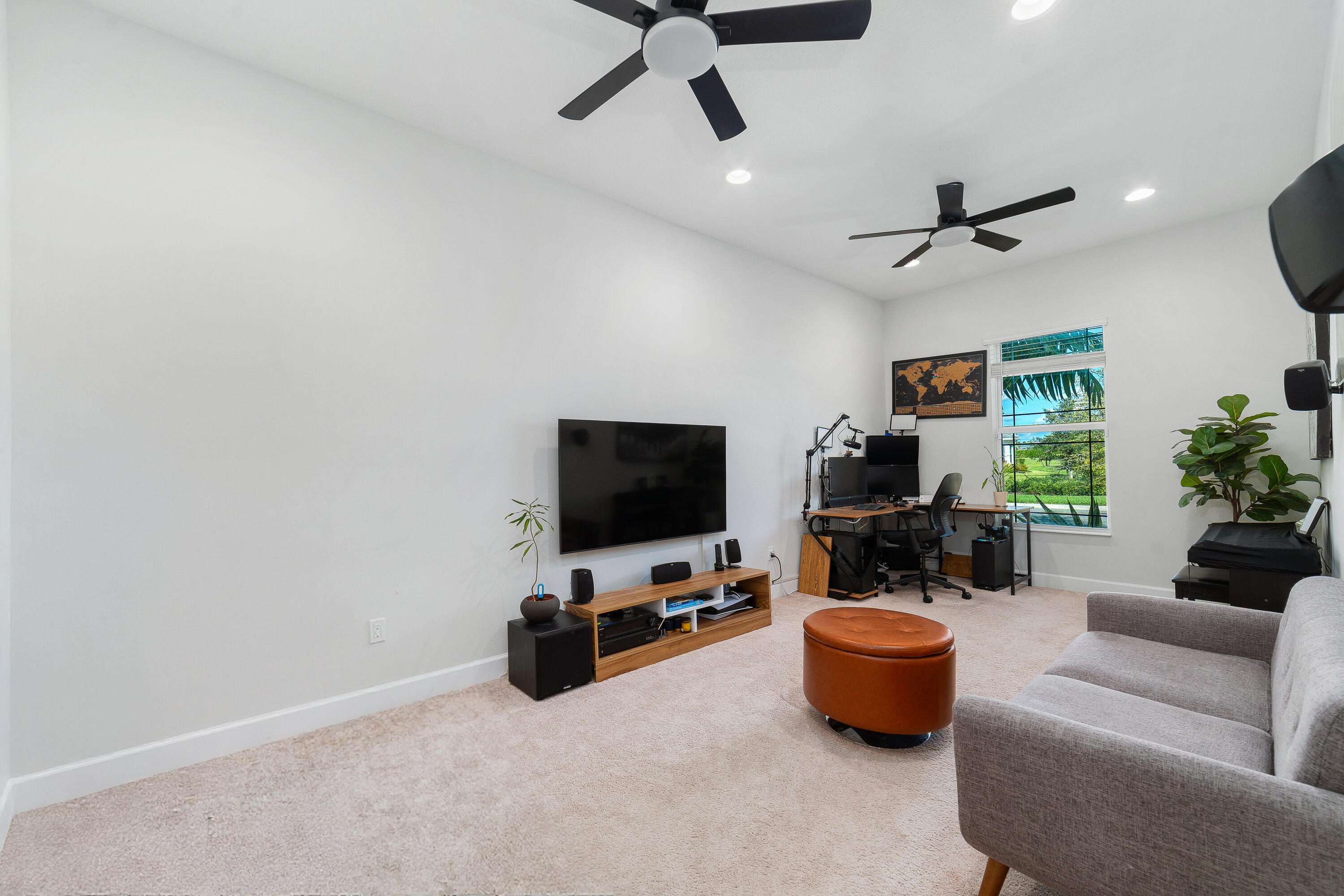 5487 Macoon Way Loxahatchee, FL 33470 - Photo 23 of 66 a living room with furniture and a flat screen tv