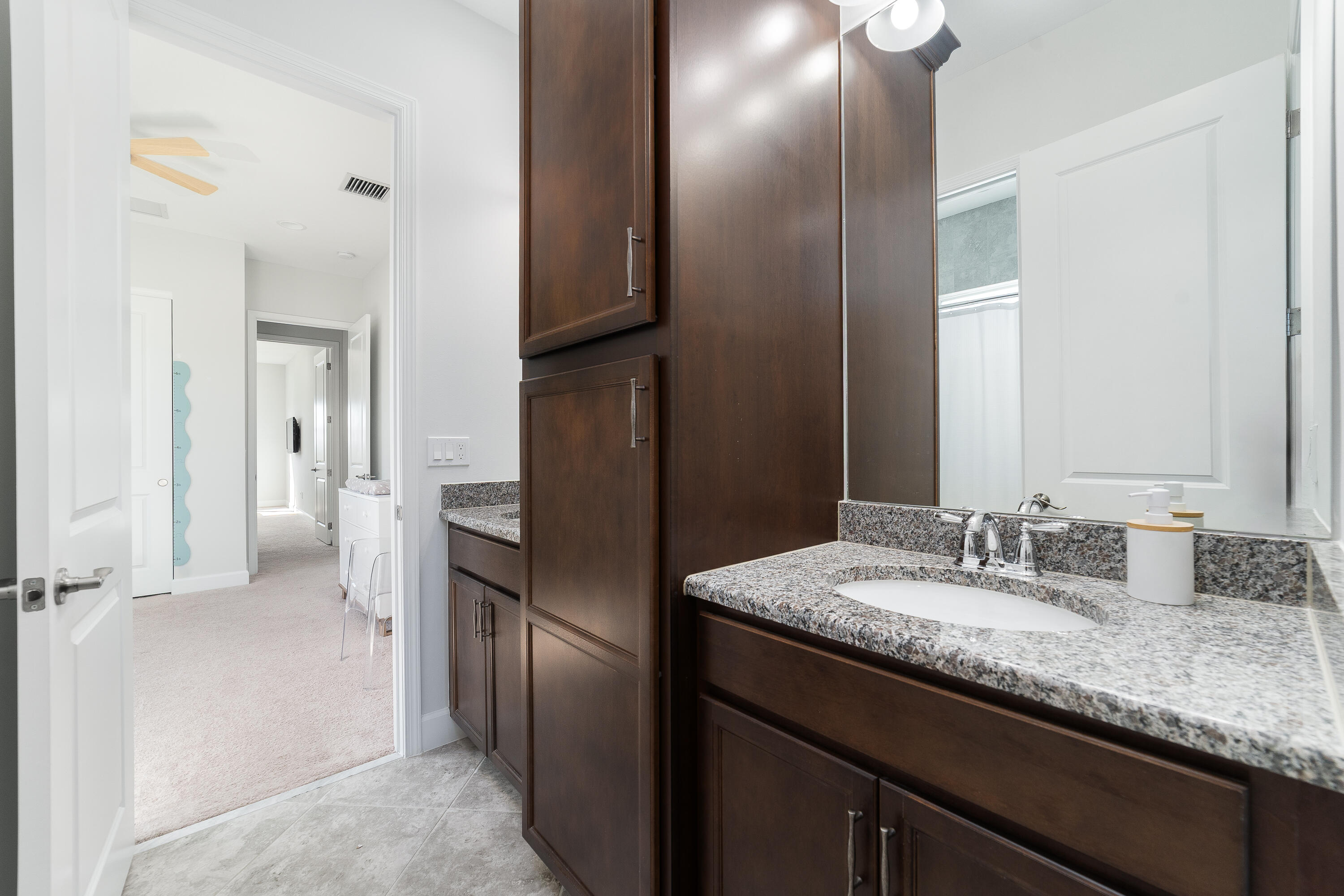 5487 Macoon Way Loxahatchee, FL 33470 - Photo 29 of 66 a bathroom with a granite countertop sink and a mirror