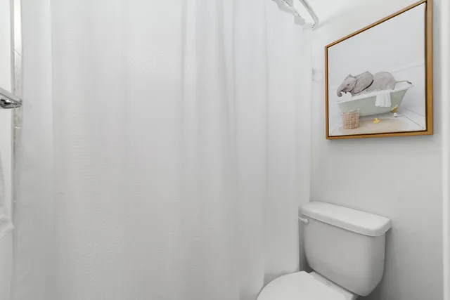 a bedroom with a bed furniture and a flat screen tv