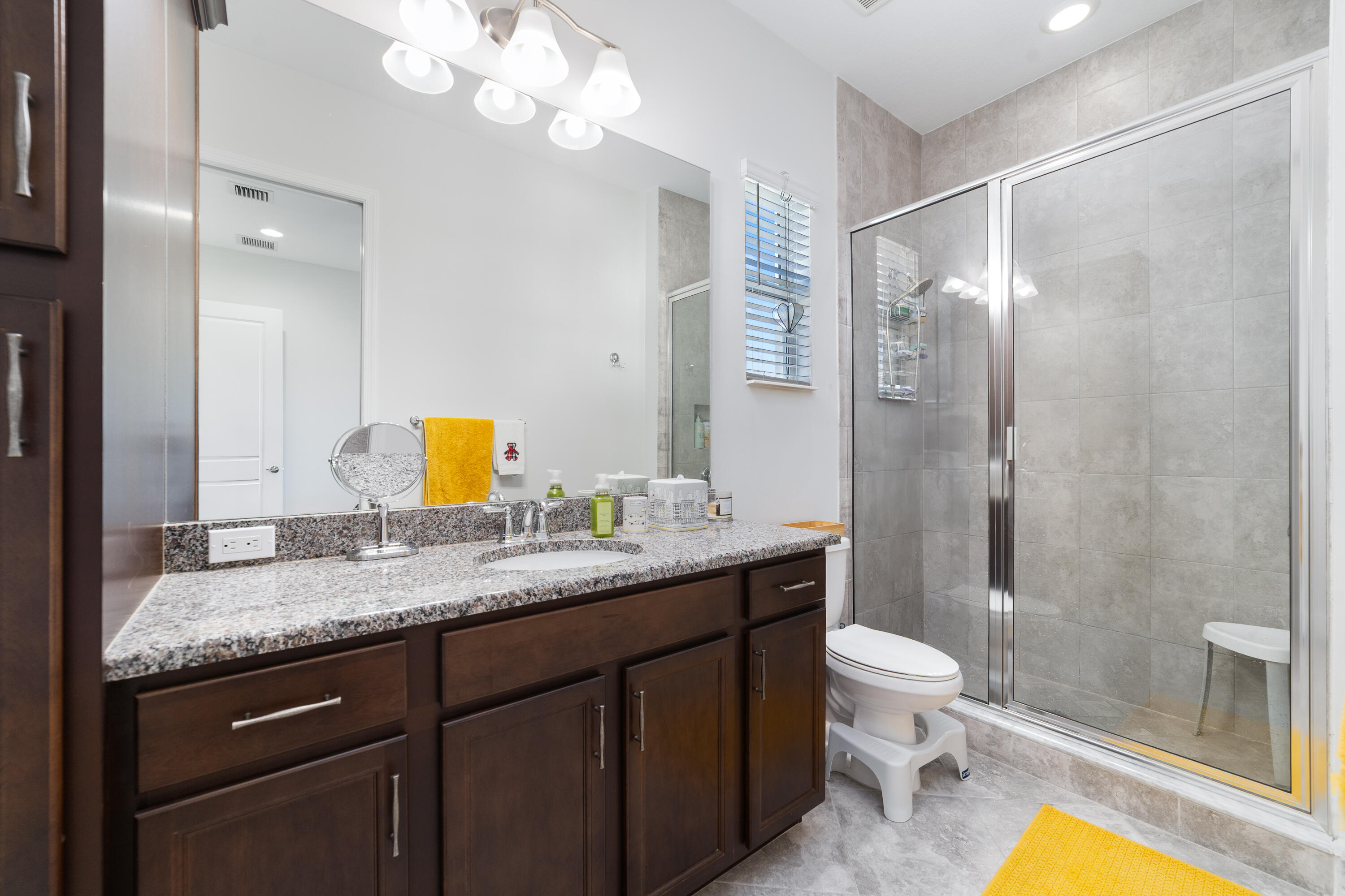 5487 Macoon Way Loxahatchee, FL 33470 - Photo 39 of 66 a bathroom with a granite countertop sink mirror vanity and toilet