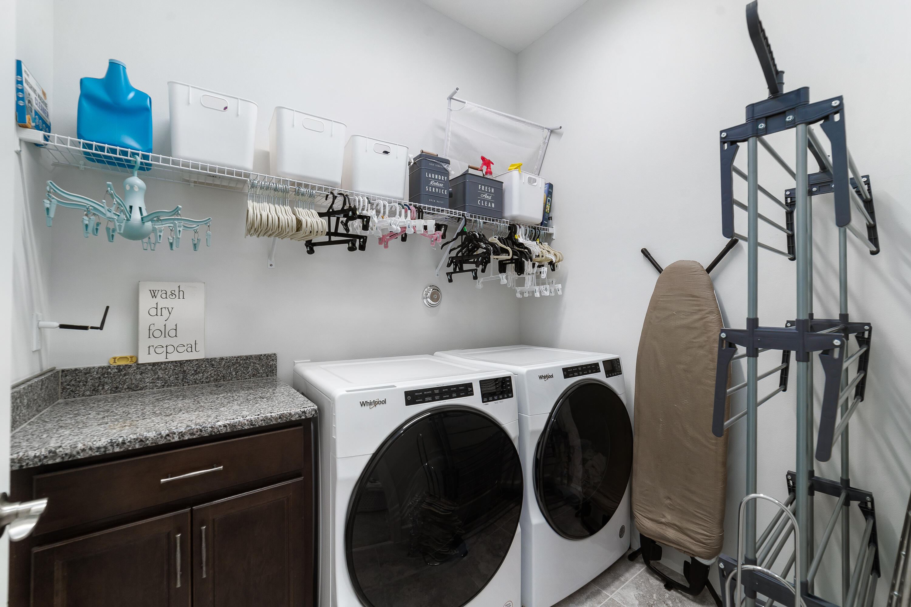 5487 Macoon Way Loxahatchee, FL 33470 - Photo 46 of 66 a view of a storage and utility room with washer and dryer