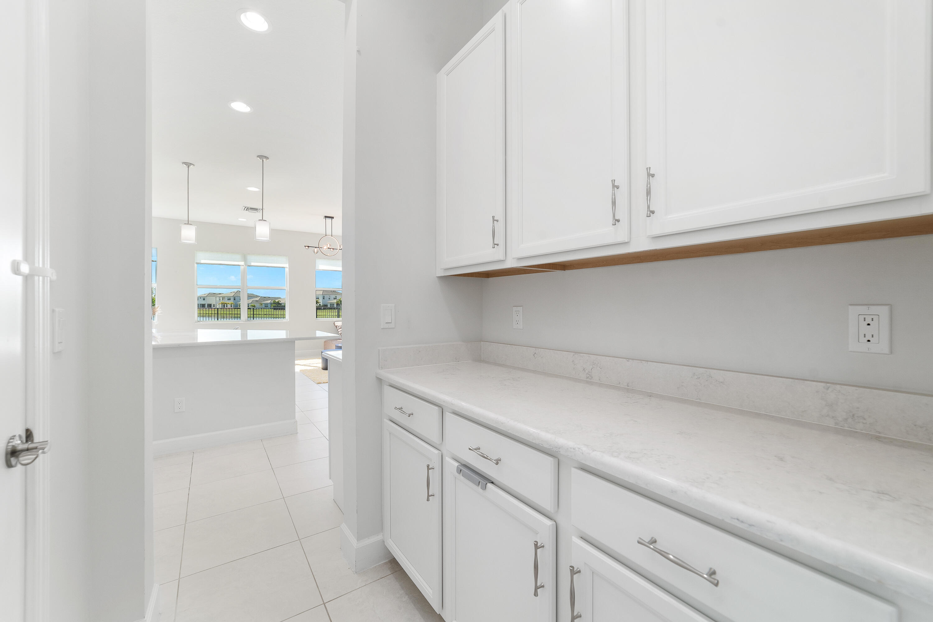 5487 Macoon Way Loxahatchee, FL 33470 - Photo 8 of 66 a kitchen with white cabinets and a sink