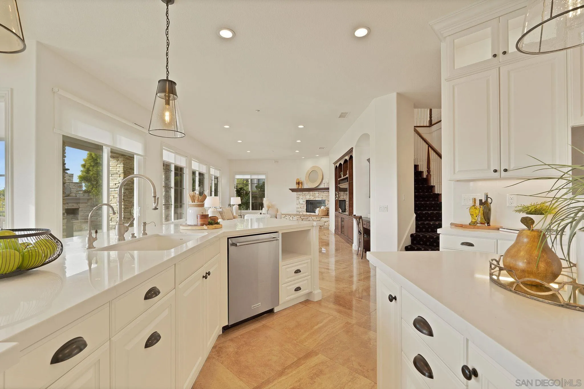 698 Cypress Hills Drive Encinitas, CA 92024 - Photo 15 of 44 a large white kitchen with stainless steel appliances granite countertop a sink and cabinets