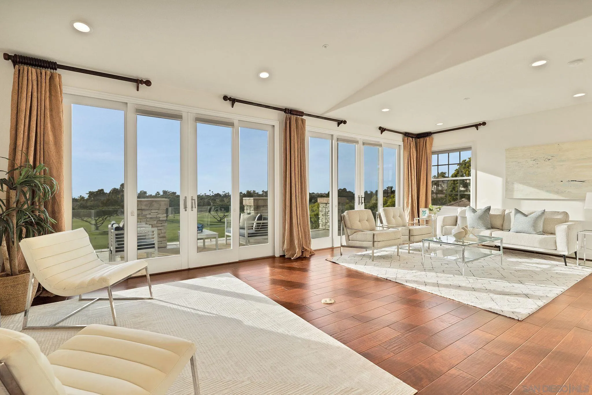 698 Cypress Hills Drive Encinitas, CA 92024 - Photo 23 of 44 a living room with furniture large windows and wooden floor