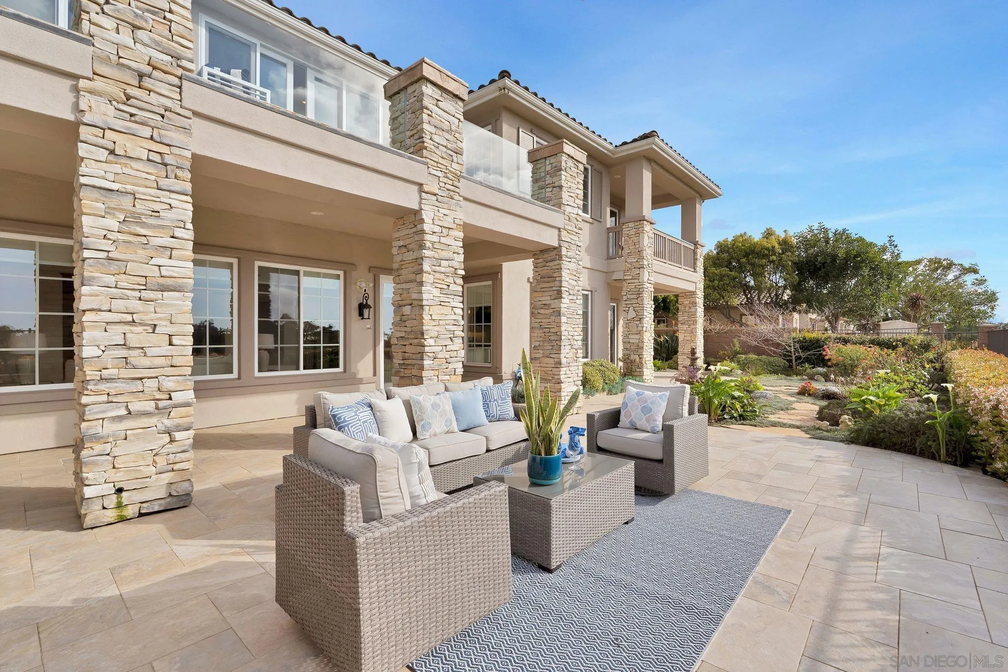 698 Cypress Hills Drive Encinitas, CA 92024 - Photo 37 of 44 a view of a patio with couches table and chairs and potted plants