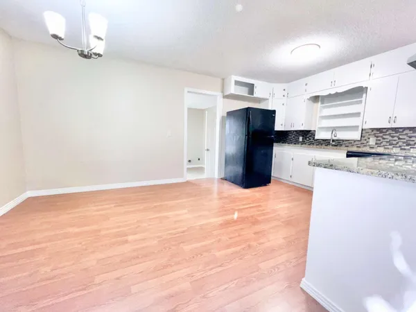 a view of a kitchen with a sink and cabinets