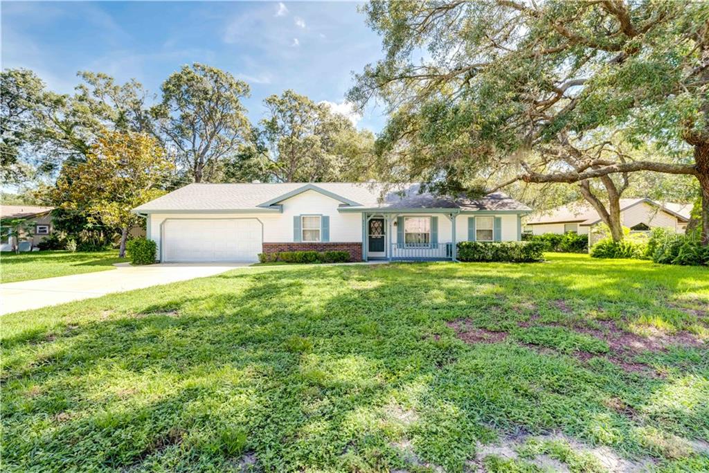 8347 Dorsey Street Spring Hill, FL 34608 - Photo 1 of 1 a front view of a house with garden