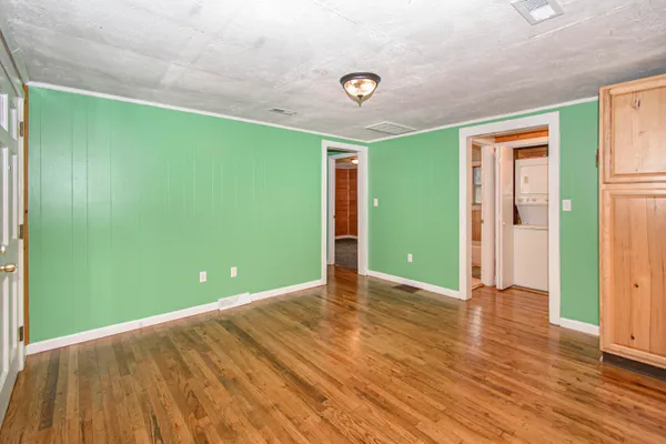 a view of room with window and wooden floor