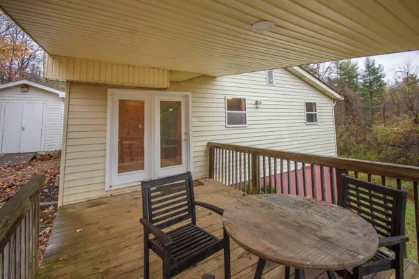 a view of a roof deck with wooden floor and fence