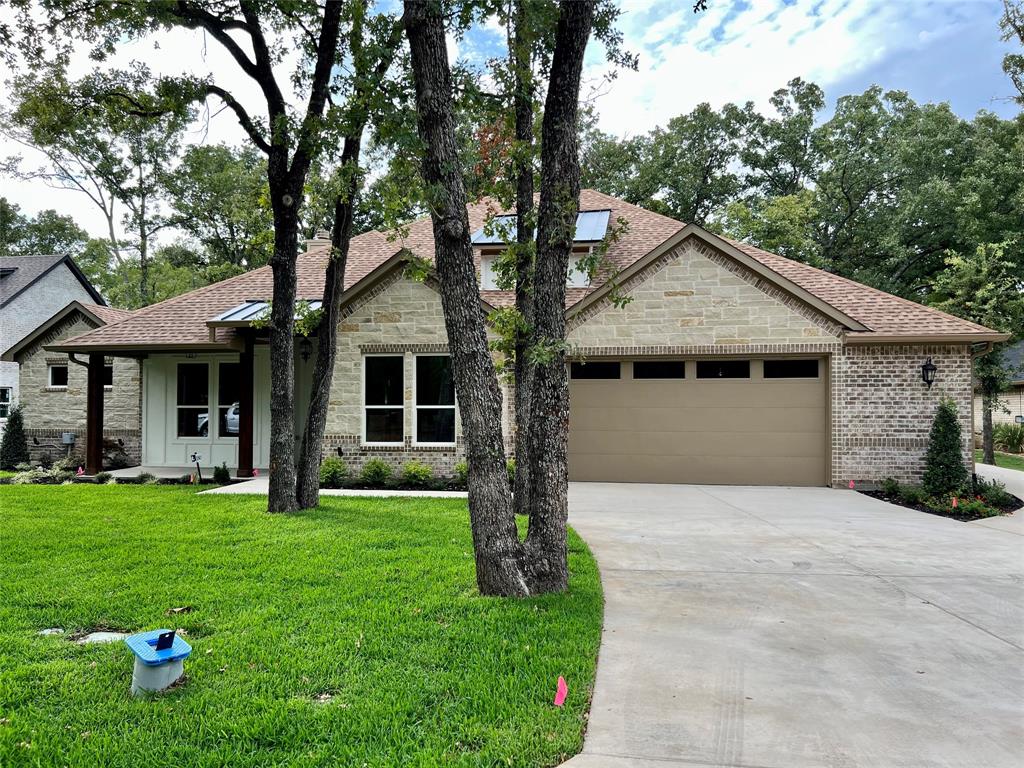 245 Colonial Drive Mabank, TX 75156 - Photo 1 of 1 a front view of a house with a garden and trees