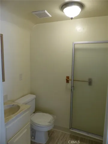 a bathroom with a toilet and a shower