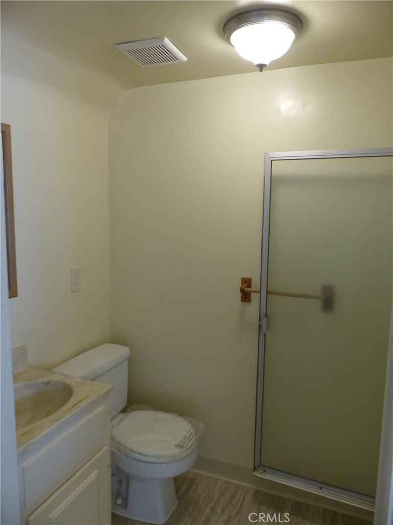 10708 Walnut Street Los Alamitos, CA 90720 - Photo 6 of 13 a bathroom with a toilet and a shower