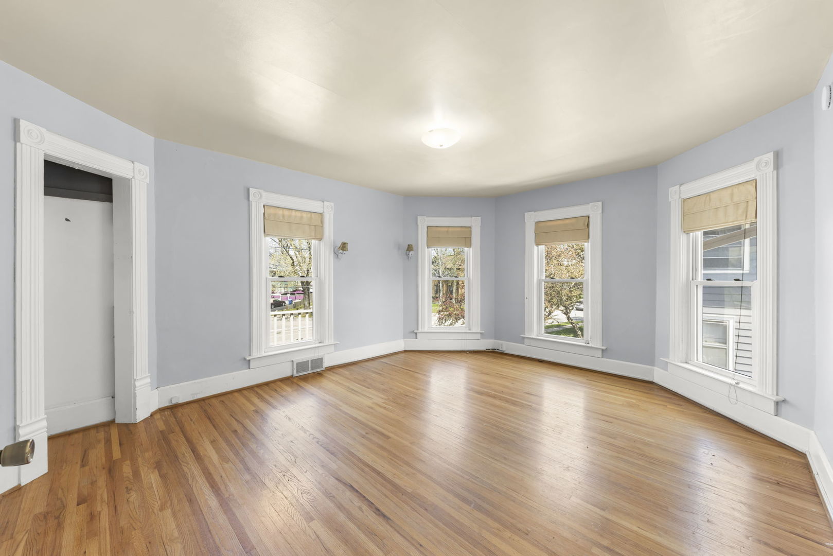 208 West Locust Street DeKalb, IL 60115 - Photo 13 of 26 a view of an empty room with wooden floor and a window