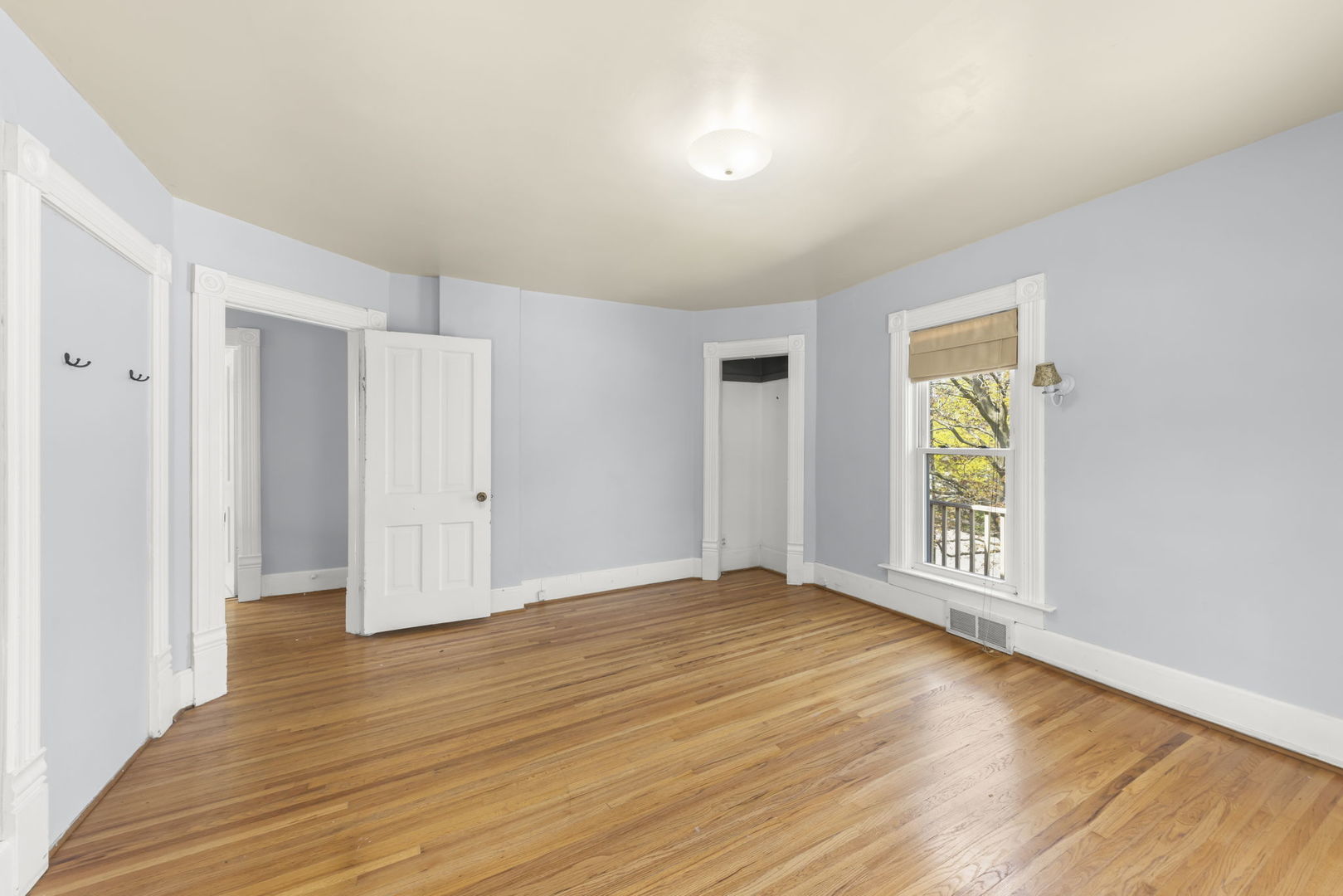 208 West Locust Street DeKalb, IL 60115 - Photo 14 of 26 a view of an empty room with wooden floor and a window