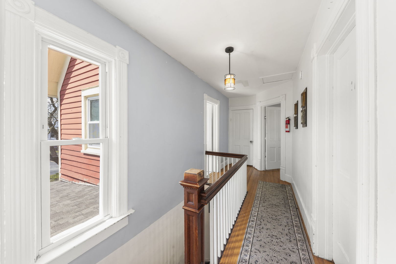 208 West Locust Street DeKalb, IL 60115 - Photo 16 of 26 a view of a hallway with windows and stairs
