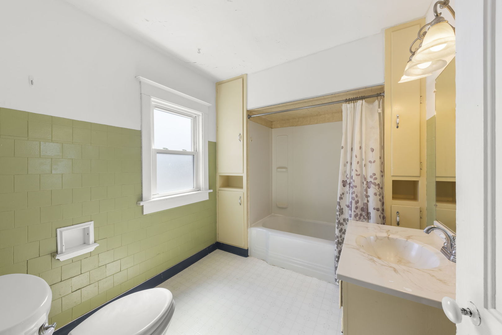 208 West Locust Street DeKalb, IL 60115 - Photo 18 of 26 a bathroom with a sink toilet and shower