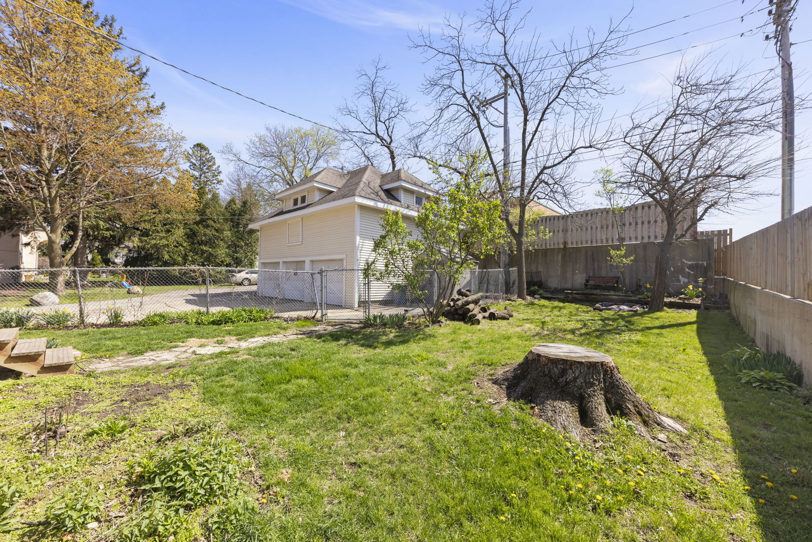 208 West Locust Street DeKalb, IL 60115 - Photo 22 of 26 a backyard of a house with table and chairs and wooden fence