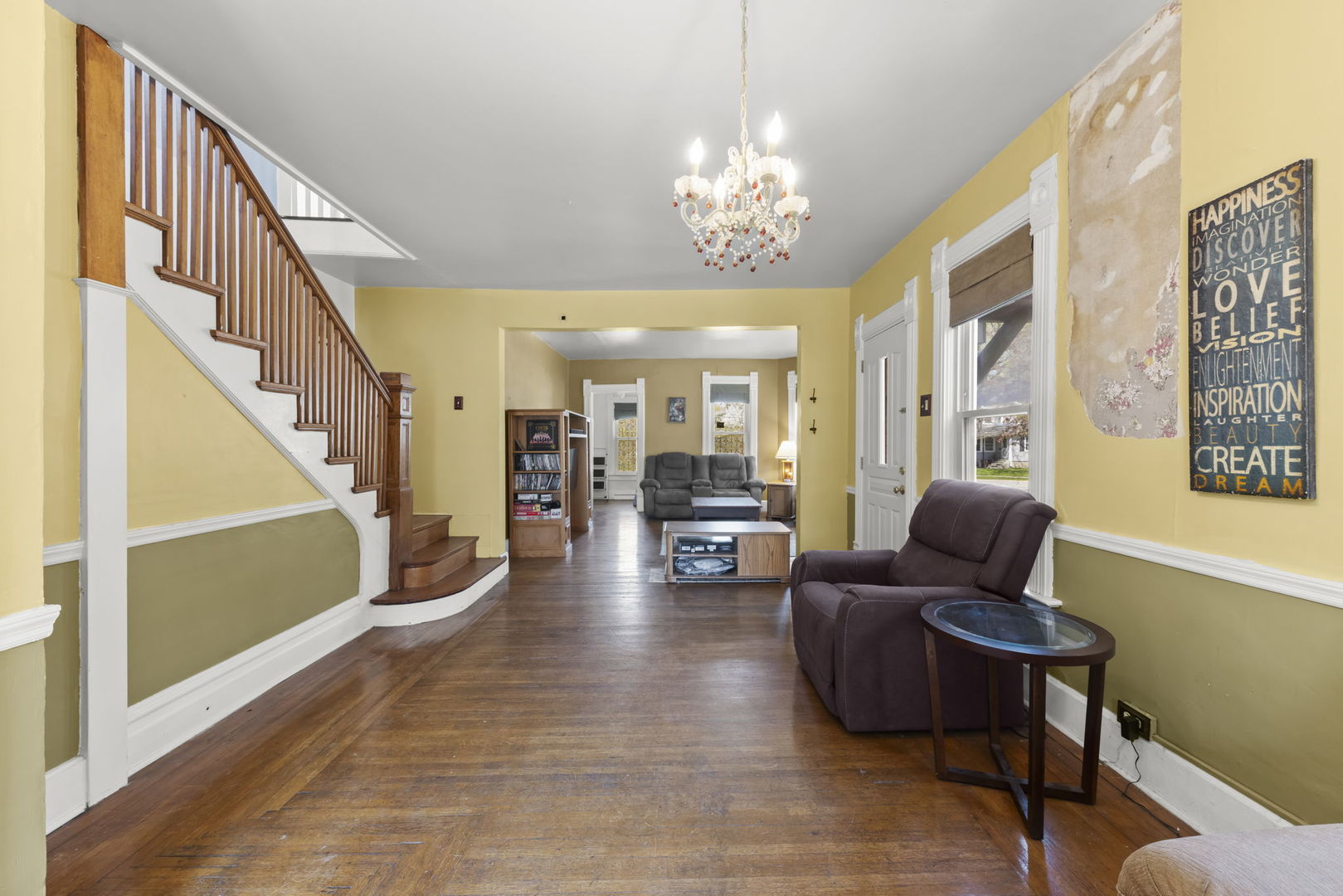 208 West Locust Street DeKalb, IL 60115 - Photo 4 of 26 a living room with furniture and a chandelier