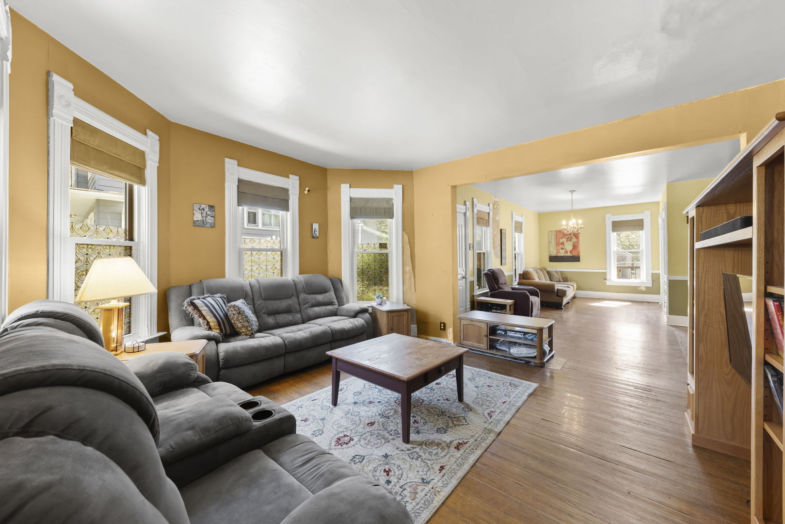 208 West Locust Street DeKalb, IL 60115 - Photo 5 of 26 a living room with furniture wooden floor and a large window