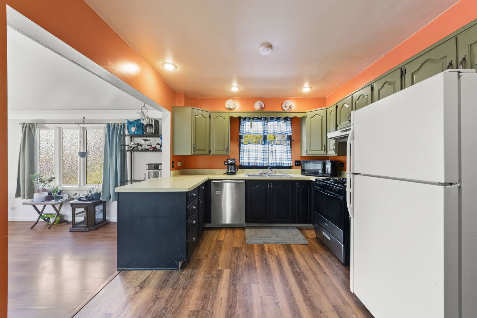 208 West Locust Street DeKalb, IL 60115 - Photo 10 of 26 a kitchen with granite countertop a refrigerator and a stove top oven