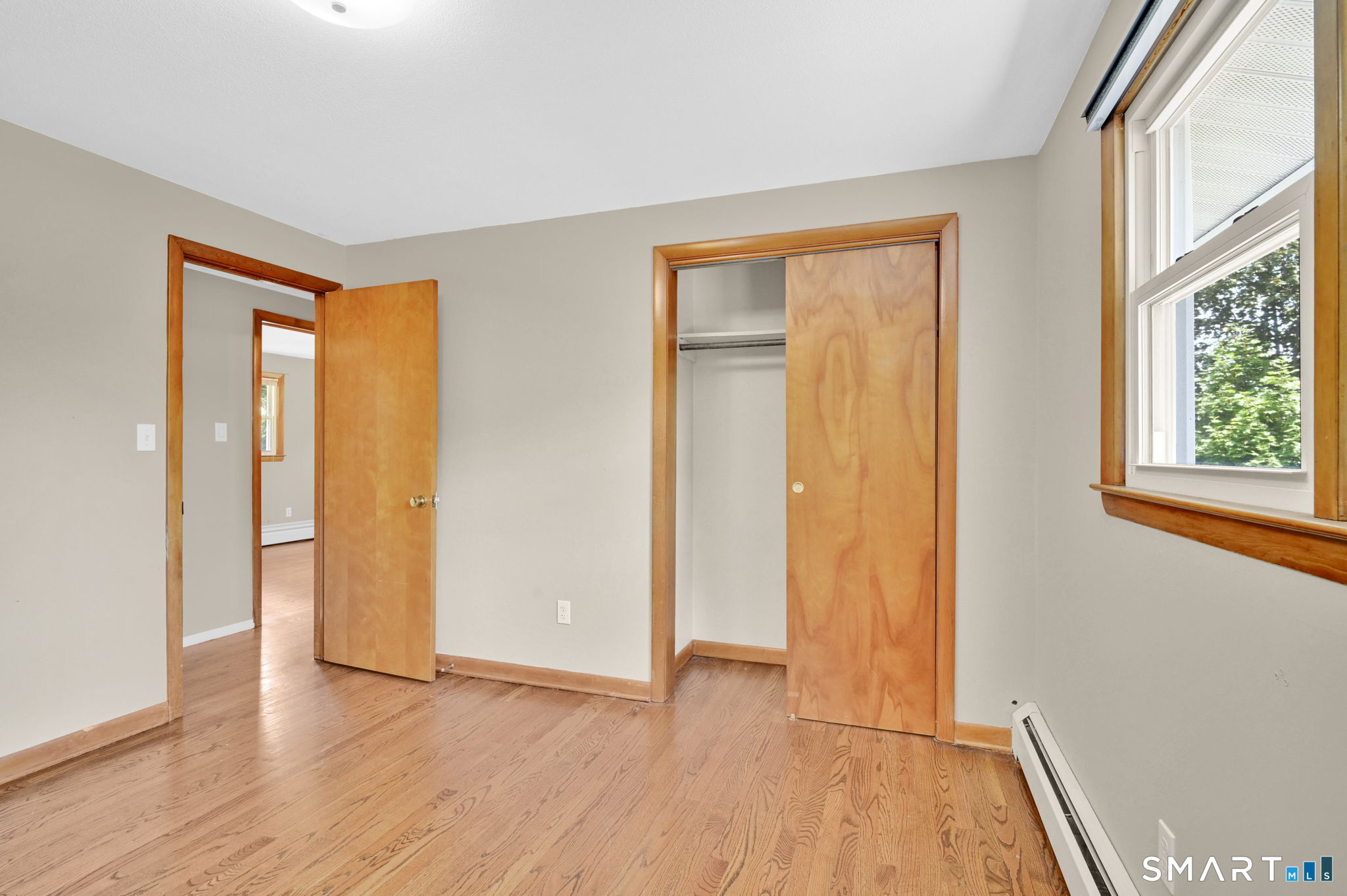 7 Rogers Drive Meriden, CT 06450 - Photo 26 of 40 a view of an empty room with wooden floor and a window