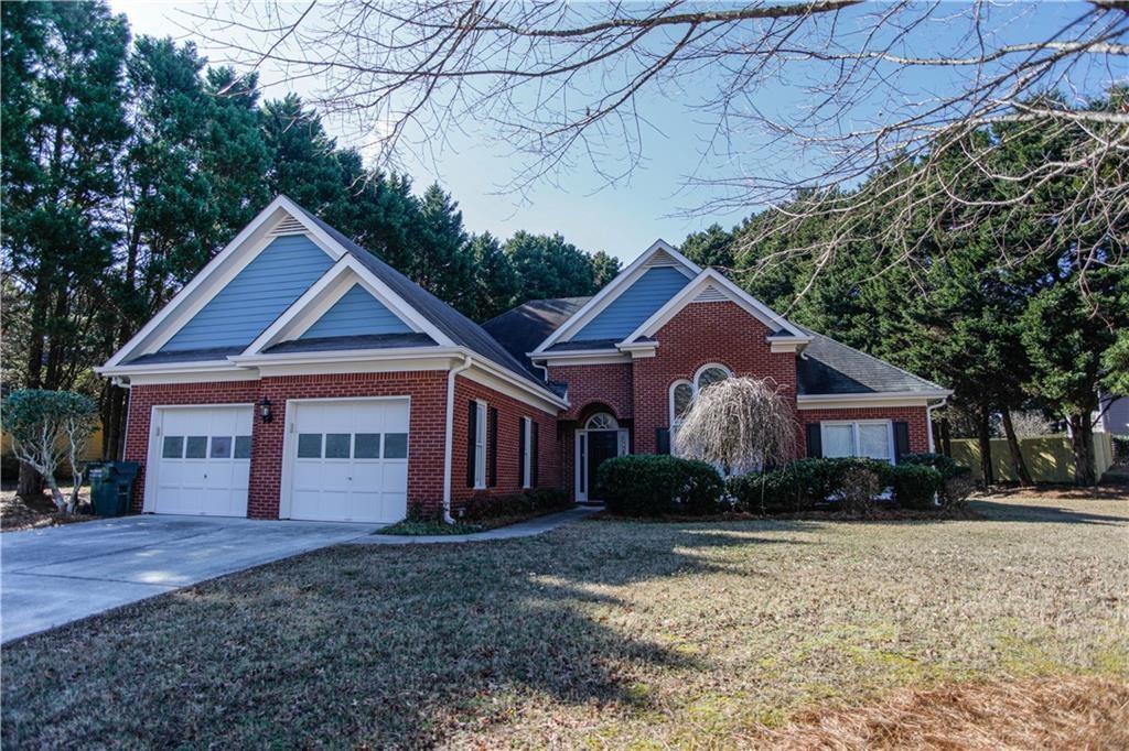 3875 Spring Manor Court Loganville, GA 30052 - Photo 1 of 23 a front view of a house with a yard and garage