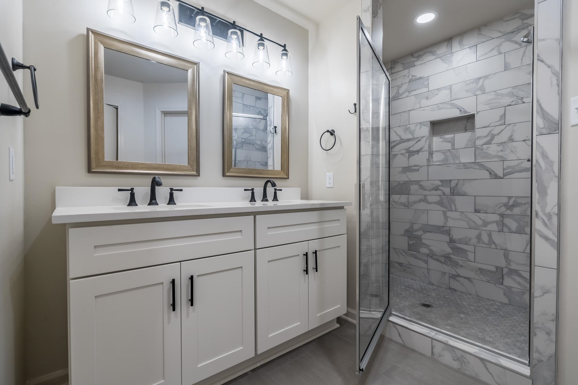 1014 Wellsville Road Memphis, TN 38117 - Photo 17 of 25 a bathroom with a shower sink and mirror