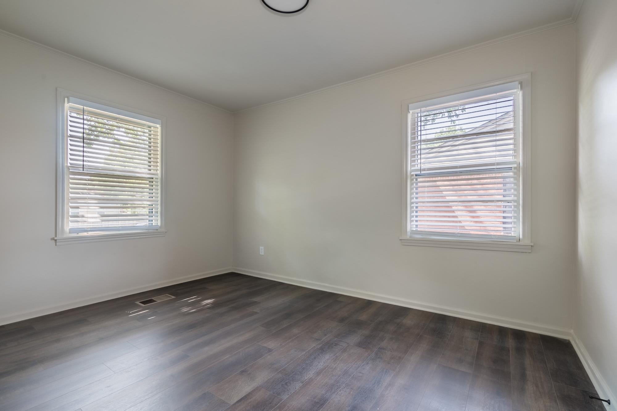 1014 Wellsville Road Memphis, TN 38117 - Photo 19 of 25 a view of an empty room with wooden floor and a window