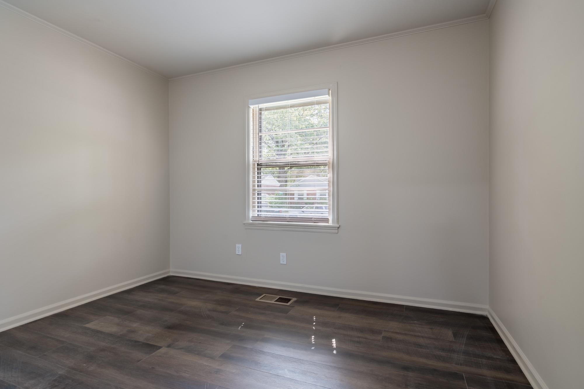 1014 Wellsville Road Memphis, TN 38117 - Photo 20 of 25 an empty room with wooden floor and window