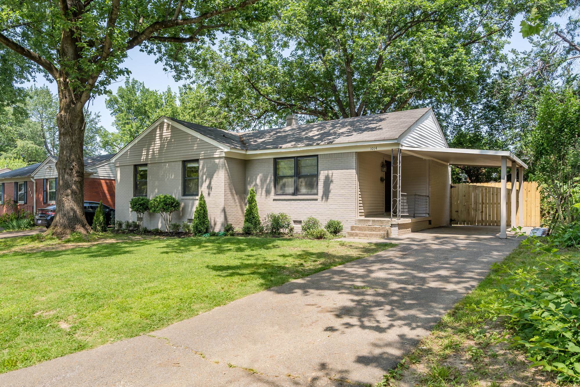 1014 Wellsville Road Memphis, TN 38117 - Photo 2 of 25 a front view of a house with a garden and trees