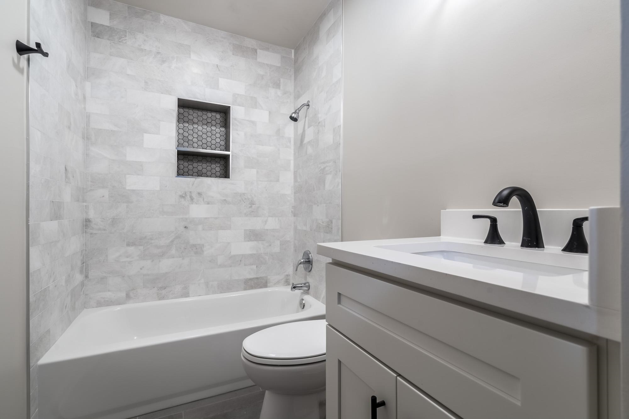 1014 Wellsville Road Memphis, TN 38117 - Photo 21 of 25 a bathroom with a sink a toilet and a bathtub