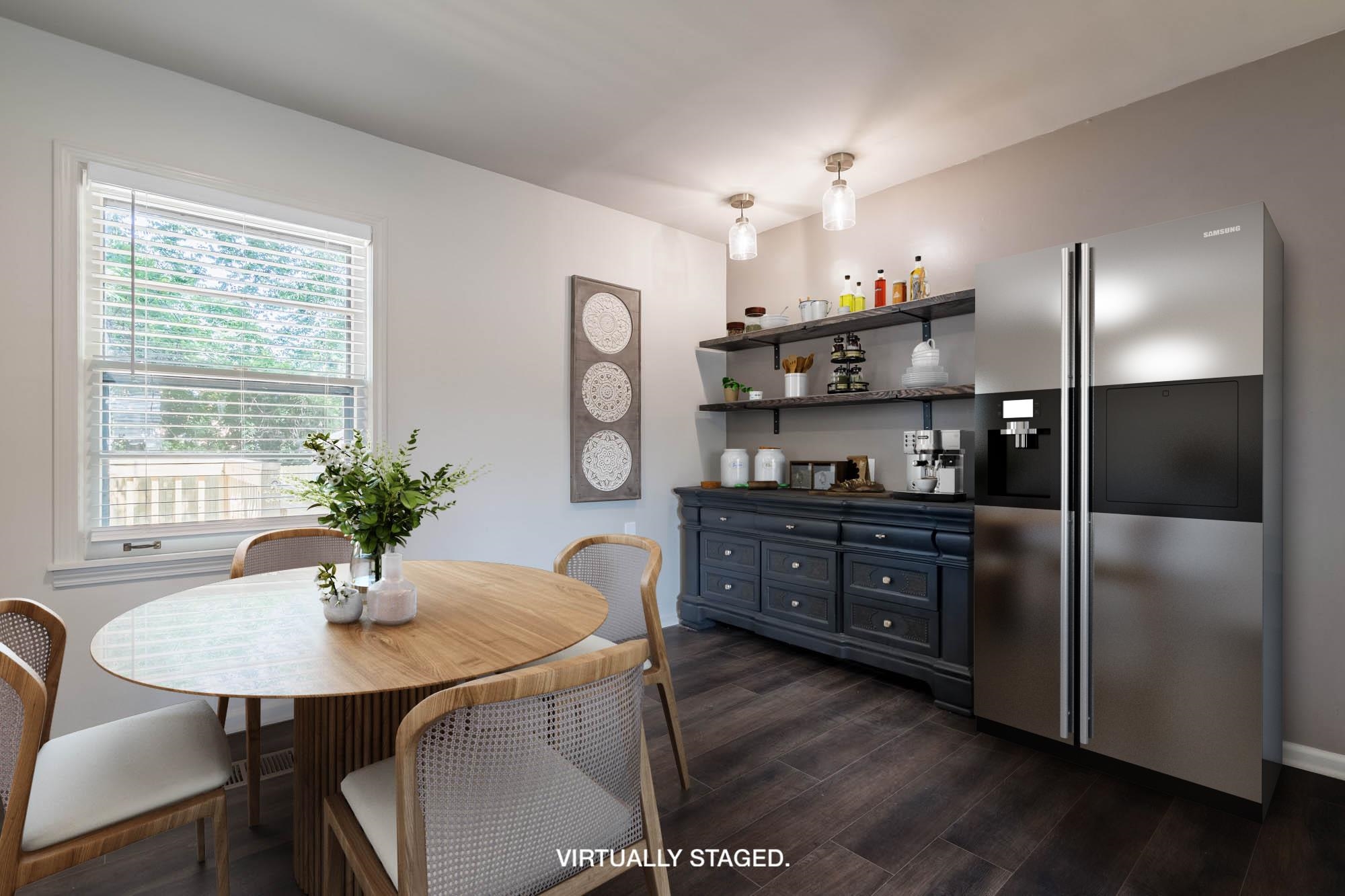 1014 Wellsville Road Memphis, TN 38117 - Photo 6 of 25 a kitchen with granite countertop a refrigerator a stove a dining table and chairs
