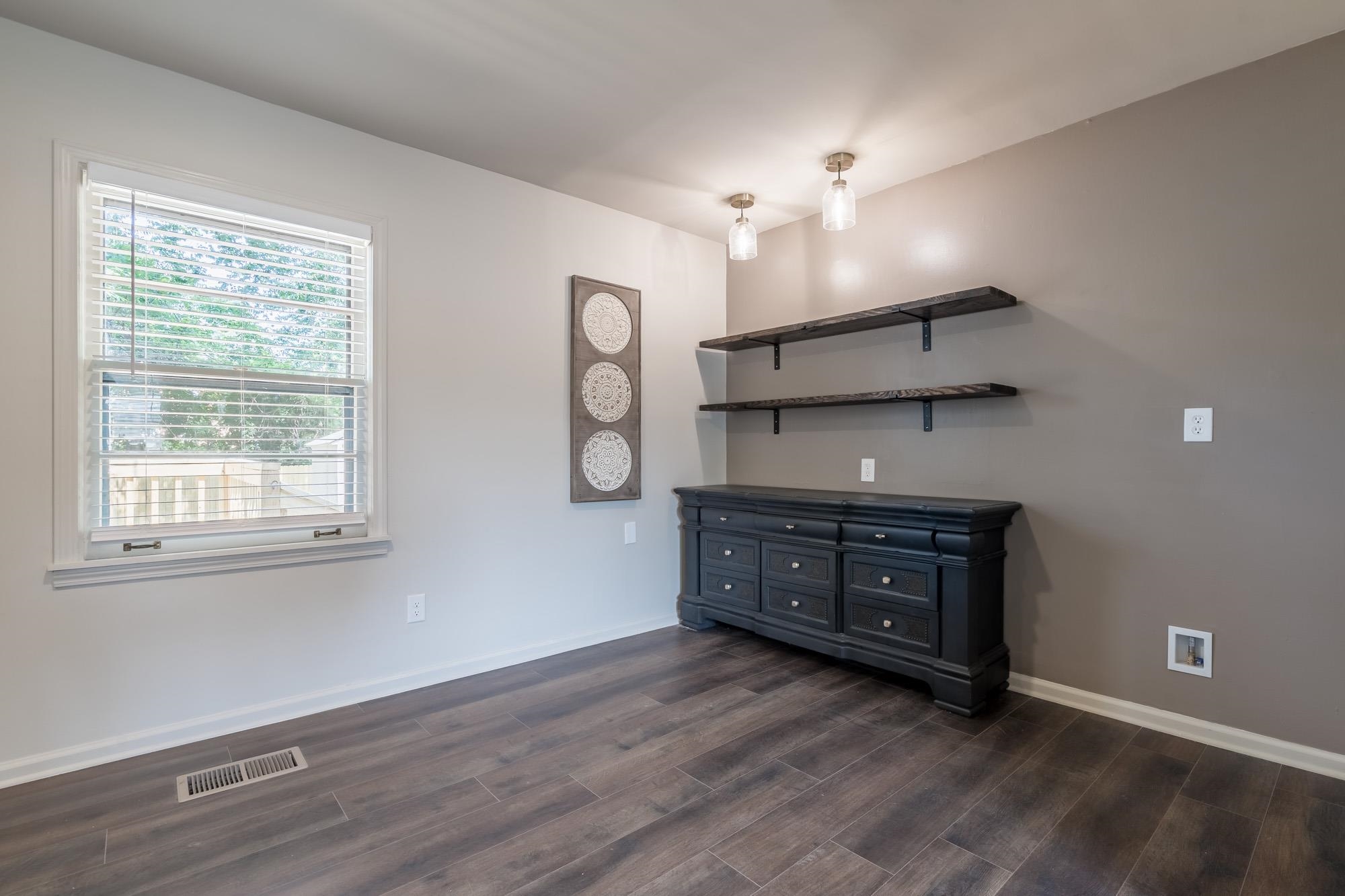 1014 Wellsville Road Memphis, TN 38117 - Photo 7 of 25 an empty room with chandelier fan and windows