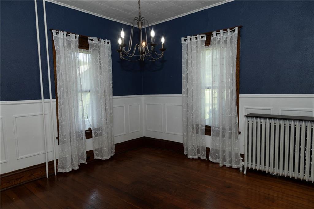 513 Lambertsville Road Stoystown, PA 15563 - Photo 11 of 49 a view of a hallway with wooden floor and chandelier